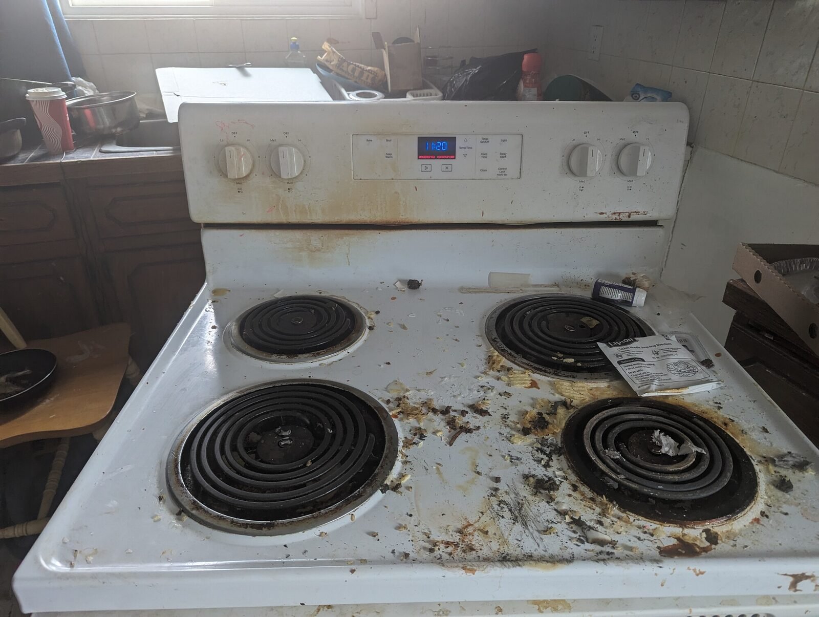 An old electric range pulled out of a kitchen for haul-away during a Clearout Crew appliance removal in the Calgary area.